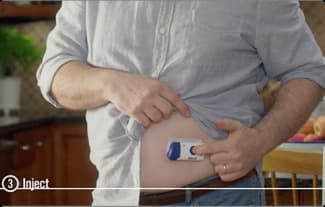 MAN PRESSES BUTTON ON MINI-DOSER MAN PRESSES BUTTON ON MINI-DOSER