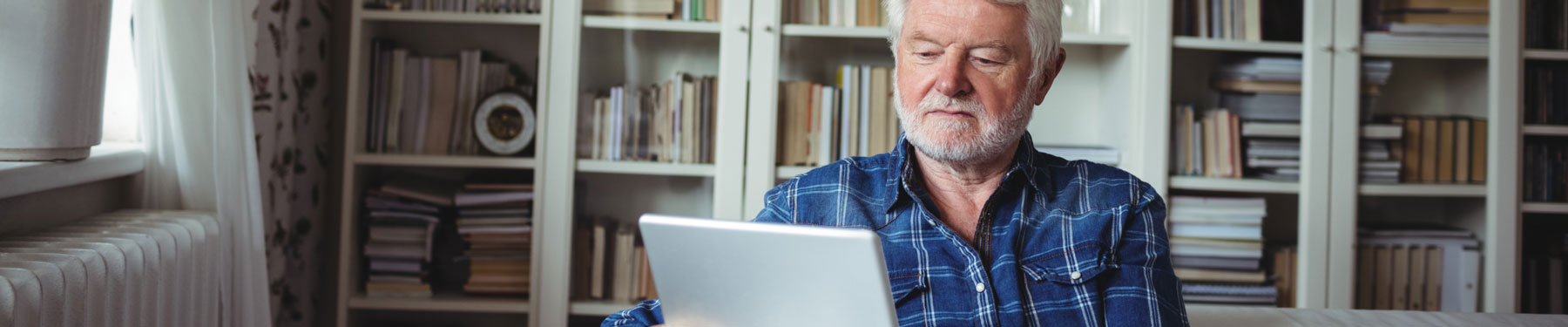 MAN LOOKS AT HIS COMPUTER